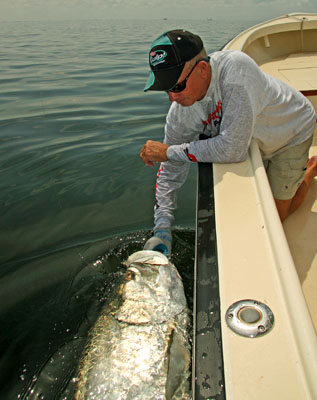 Capt. Bill Miller finds artificial lures highly effective at tempting summer tarpon.